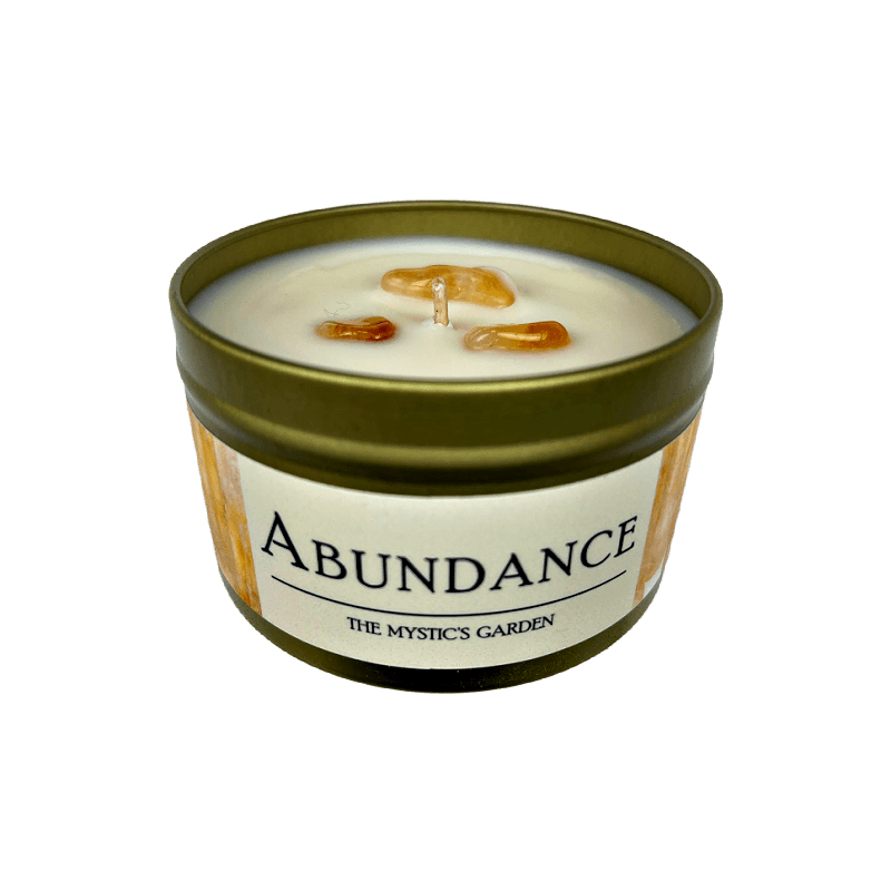 Abundance Candle top and front view of gold tin with white label set on a white background