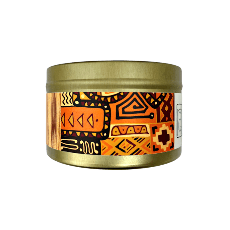 Palo Santo gold tin candle with orange abstract design set on a white background