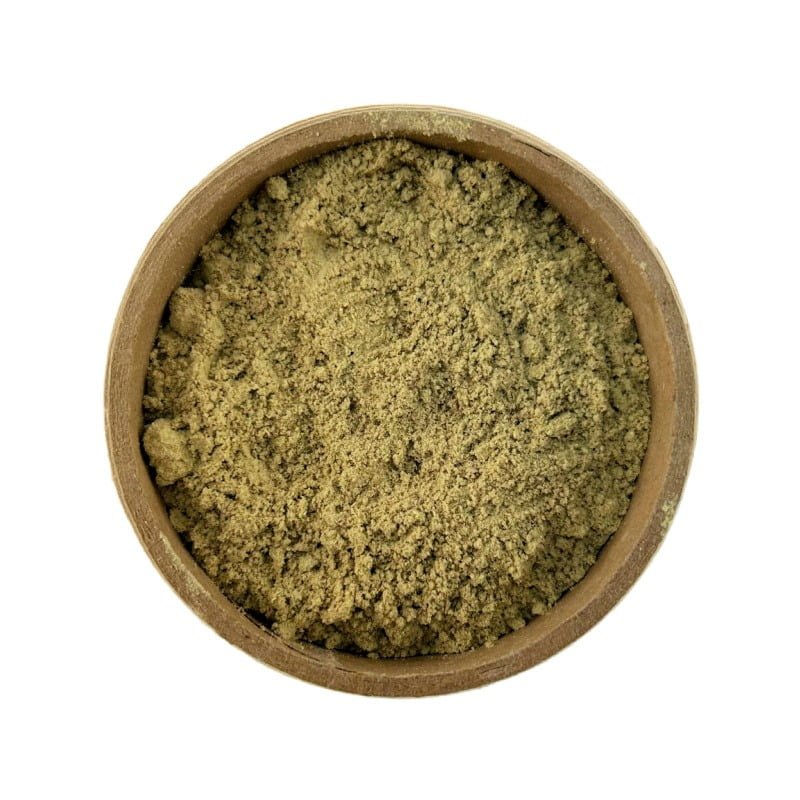 A top-down view of a bowl filled with greenish-brown powder, isolated on a white background.