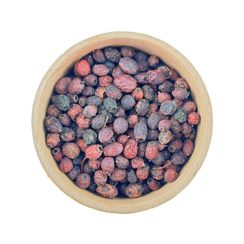 Top view of a bowl filled with dried Hawthorne Berries isolated on a white background.