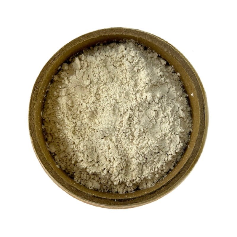 A top-down view of a bowl filled with shatavari root powder on a white background.