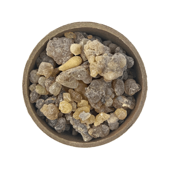 Frankincense Carterii Resin in a brown bowl set on a white background