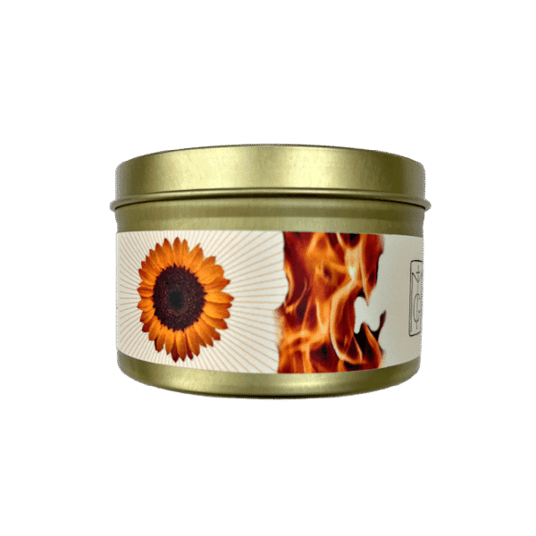 Solstice candle in a gold tin with white and orange label with fire and sunflower set on a white background