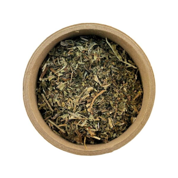 A top view of a round container filled with loose, dried herbs on a white background.