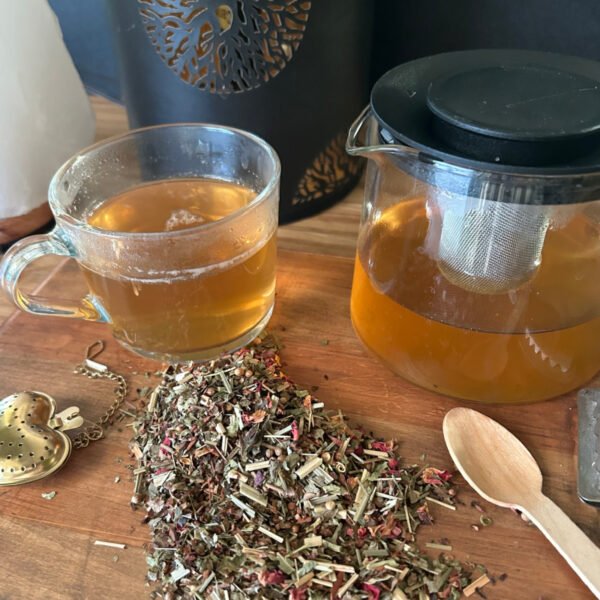 Home Herbal tea in glass mug with loose botanical tea blends.