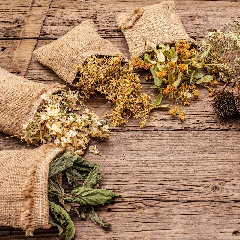 Dried herbs in sacks placed on table